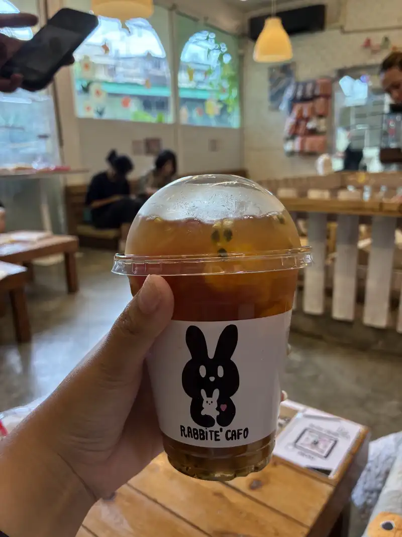 Iced tea in a Rabbito Cafe cup inside the cafe